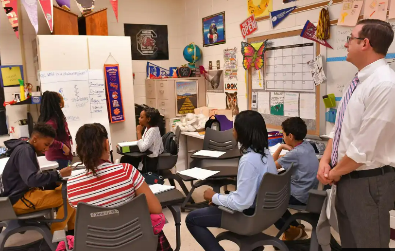 In this file photo from February 2020, Carver students participate in classroom situations with AVID instructor Patrick Donnelly, right, at the school.