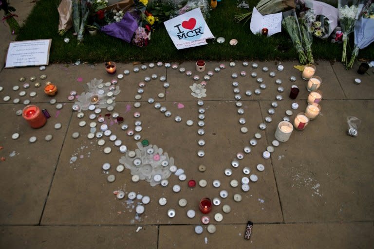 Floral tributes, messages and candles are left in Manchester in tribute to the victims of Monday's attack at a concert venue in the city