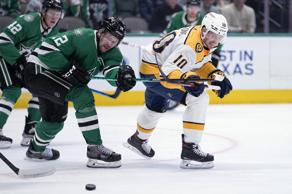 Dallas Stars center Radek Faksa (12) and Nashville Predators center Colton Sissons (10) chase the puck in the first period of an NHL hockey game, Monday, April 3, 2023, in Dallas. (AP Photo/Tony Gutierrez)