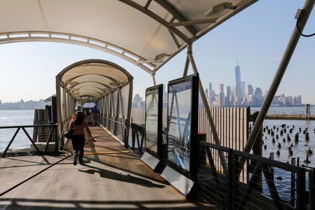 People walk to the ferry after arriving at the Hoboken Terminal in New Jersey, U.S., July 10, 2017. REUTERS/Eduardo Munoz