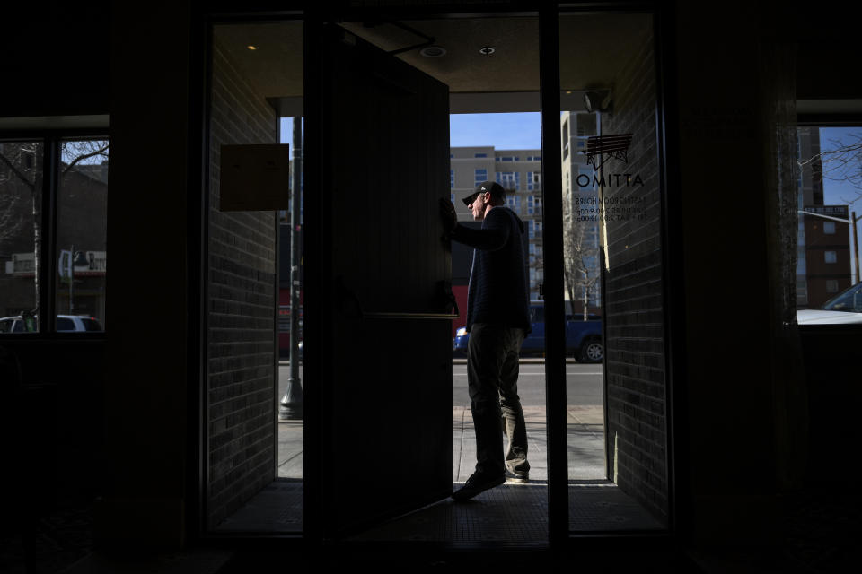 DENVER, CO - MARCH 16: Owner of Attimo Wine Jon Schlegel speaks to passing workers to give support after a citywide closure of bars and restaurants was announced on Monday, March 16, 2020. Mayor Michael B. Hancock announced that starting on March 17, restaurants, bars and hookah bars would be closed to in-house service. (Photo by AAron Ontiveroz/MediaNews Group/The Denver Post via Getty Images)