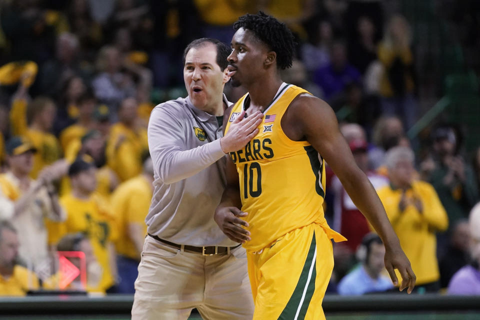 Baylor coach Scott Drew, left, congratulates guard Adam Flagler (10) during a timeout in the first half of the team's NCAA college basketball game against TCU in Waco, Texas, Wednesday, Jan. 4, 2023. (AP Photo/LM Otero)