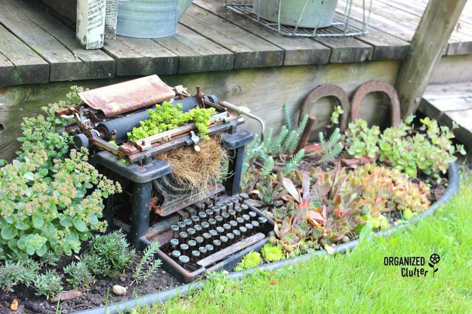 10) Vintage Typewriter Turned Garden Statue