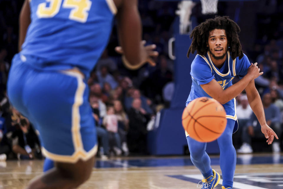 UCLA guard Tyger Campbell passes the ball during the first half of an NCAA college basketball game against Kentucky in the CBS Sports Classic, Saturday, Dec. 17, 2022, in New York. (AP Photo/Julia Nikhinson)