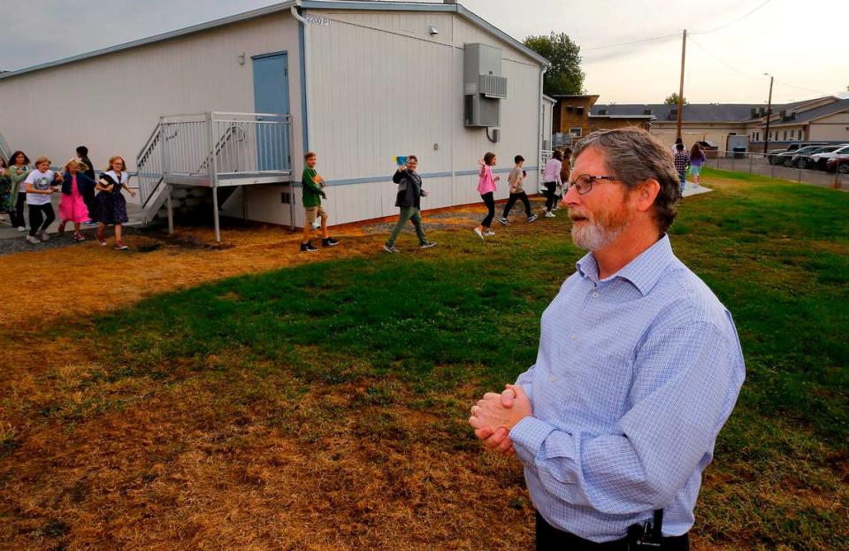 Jim Cochran, superintendent at Liberty Christian School in Richland, stands outside near three modular classroom buildings added in the past three years.
