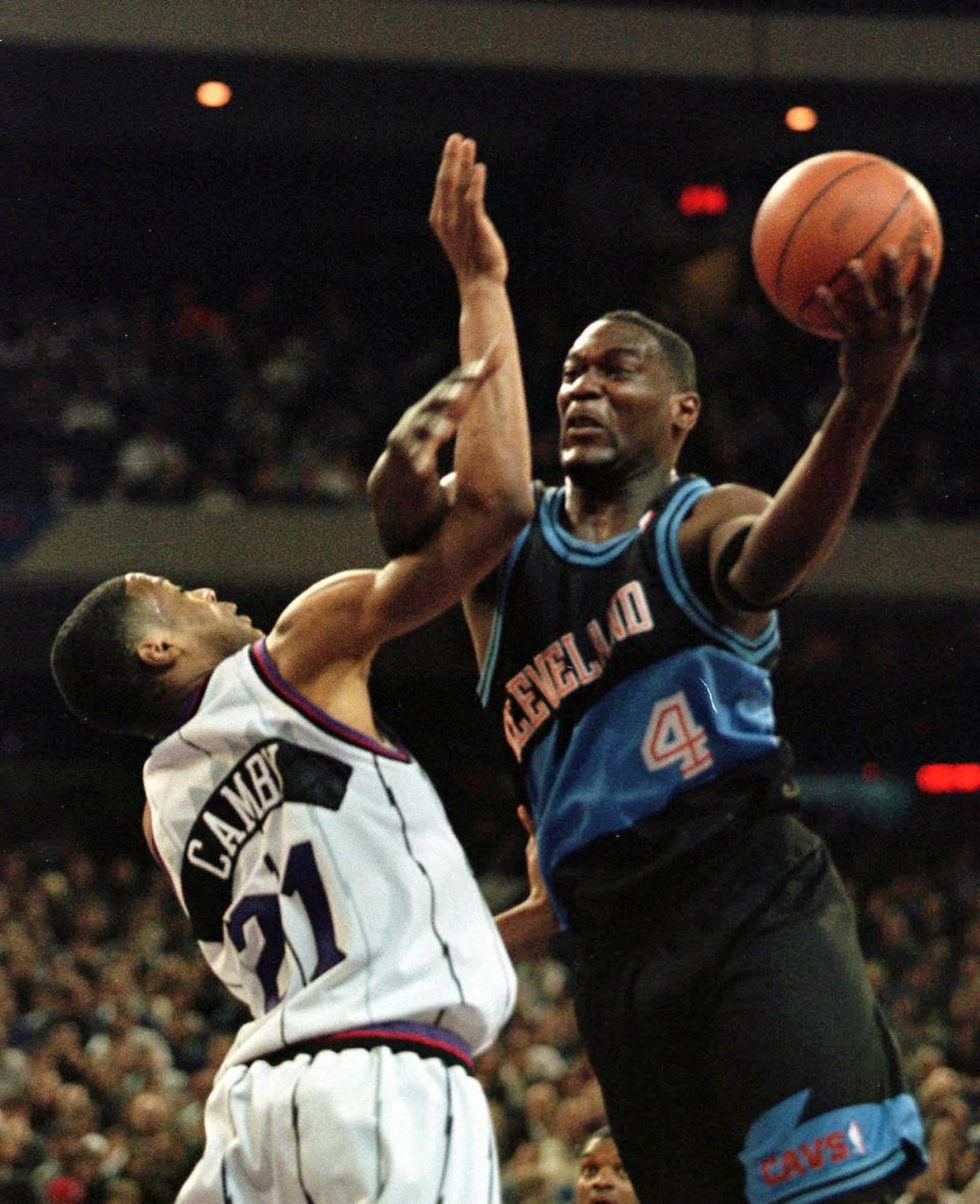 Cleveland Cavaliers' Shawn Kemp right tries for a basket but is blocked by Toronto Raptors' Marcus Camby during NBA action in Toronto Thursday March 26 1998.