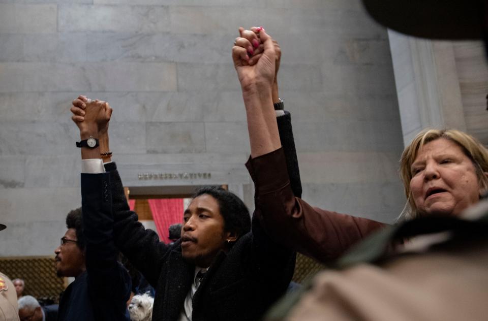 Rep. Justin Pearson, Rep. Justin Jones, Rep. Gloria Johnson People hold their hands up as they exit the House Chamber doors at Tennessee State Capitol Building in Nashville , Tenn., Monday, April 3, 2023.