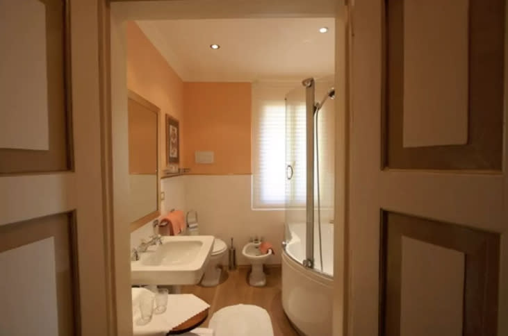<p>They are separated by a large bathroom with a shower, tub and bidet. </p>