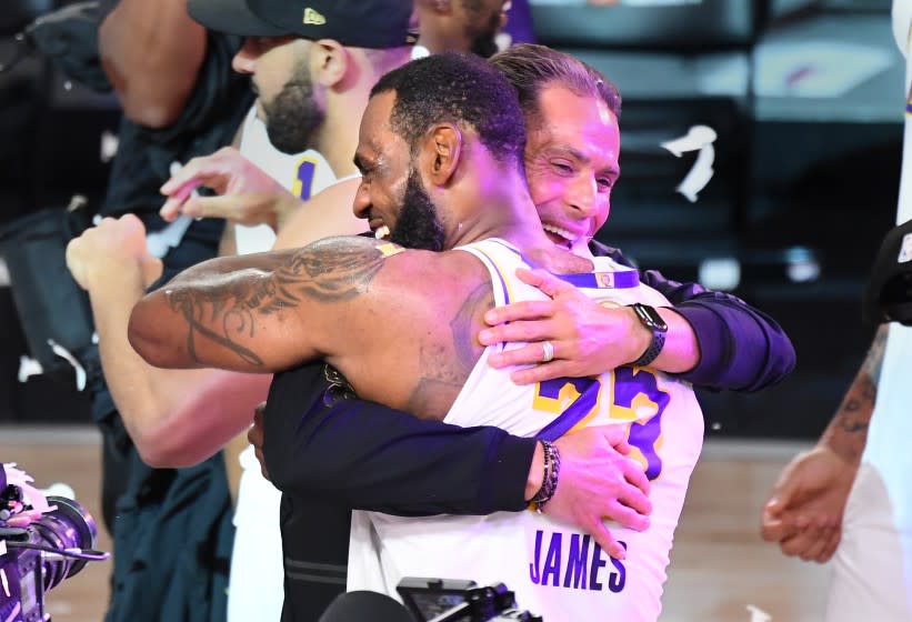 ORLANDO, FLORIDA OCTOBER 11, 2020- Lakers LeBron James hugs GM Rob Pelinka.