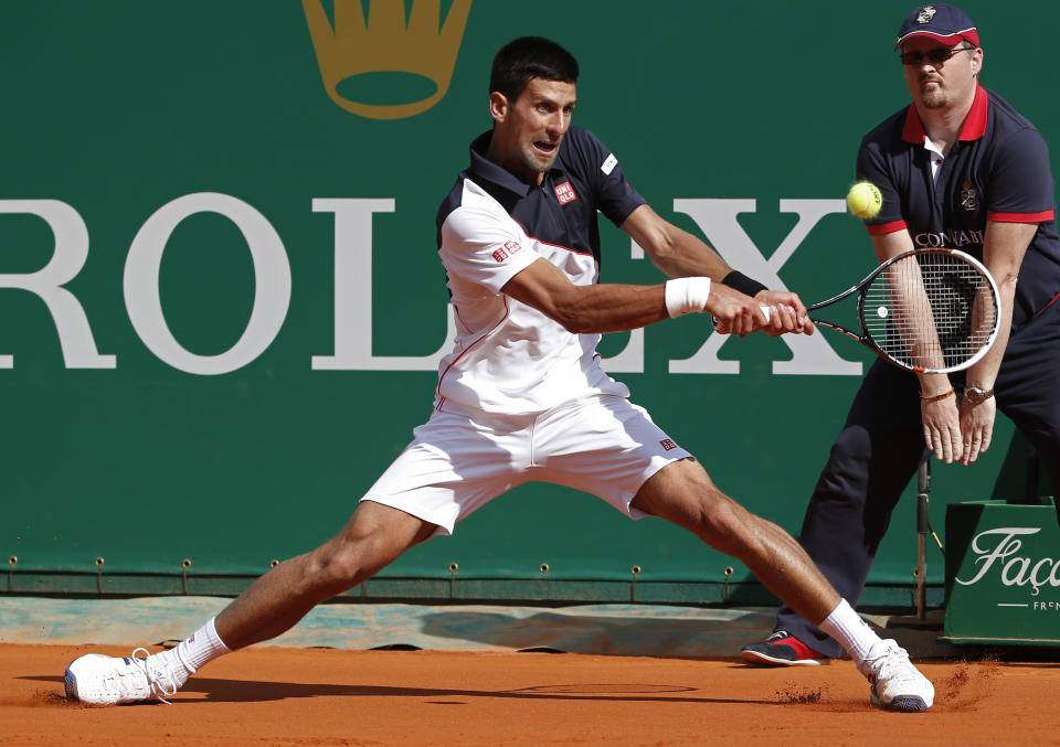 Novak Djokovic of Serbia, returns the ball to Pablo Carreno Busta of Spain during their third round match of the Monte Carlo Tennis Masters tournament in Monaco, Thursday, April 17, 2014. Djokovic won 6-0 6-1. (AP Photo/Michel Euler)