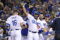 Members of the Los Angeles Dodgers celebrate as Will Smith, left, score after hitting a three-run walk off home run during the ninth inning of a baseball game against the San Francisco Giants Tuesday, July 20, 2021, in Los Angeles. (AP Photo/Mark J. Terrill)