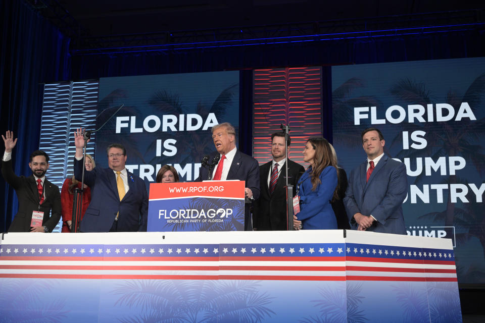 Former President Donald Trump, center, is surrounded on stage by supporters at the Republican Party of Florida Freedom Summit, Saturday, Nov. 4, 2023, in Kissimmee, Fla. (AP Photo/Phelan M. Ebenhack)