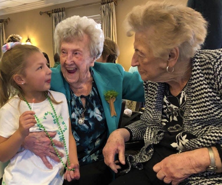 The delight that Mary Warren, center, has always taken in children shows on her face at her 100th birthday party at The Common Market in Quincy on Saturday, March 18, 2023.