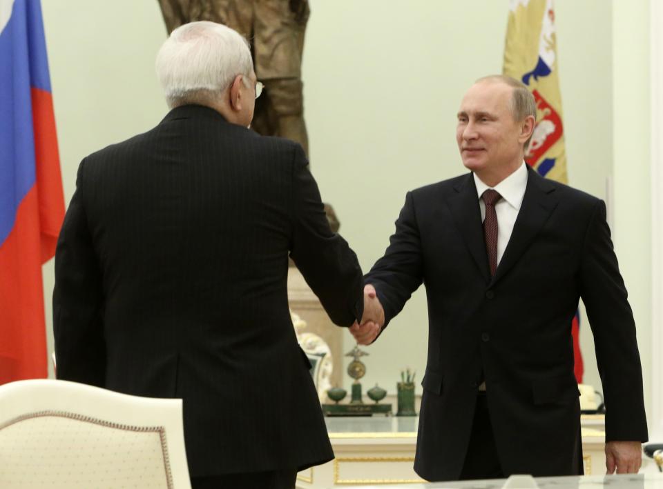 Russian President Vladimir Putin shakes hands with Iranian Foreign Minister Mohammad Javad Zarif during their meeting in the Kremlin in Moscow, Russia, Thursday, Jan. 16, 2014. Putin credited Tehran for the success of international talks on the Iranian nuclear program and called for boosting Russian-Iranian trade. (AP Photo/Sergei Karpukhin, Pool)