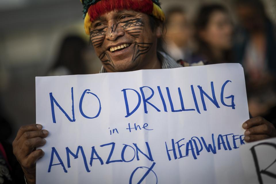 A member of the indigenous people of Ecuador attends a protest at the COP25 summit in Madrid, Wednesday Dec. 11, 2019. World leaders agreed in Paris four years ago to keep global warming below 2 degrees Celsius (3.6 degrees Fahrenheit), ideally no more than 1.5 C (2.7 F) by the end of the century. Scientists say countries will miss both of those goals by a wide margin unless drastic steps are taken to begin cutting greenhouse gas emissions next year. Claiming that the message doesn't seem to be getting through to governments, over one hundred activists led by representatives of indigenous peoples from Latin and North America made their way to the talks' venue, blocking for some tense minutes the entrance to a plenary meeting where U.N. Secretary General António Guterres was about to speak. (AP Photo/Bernat Armangue)