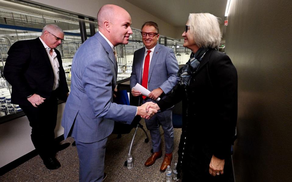 Gov. Spencer J. Cox shakes talks with President Elizabeth Cantwell, Utah State University and President Taylor Randall, University of Utah after a press conference at bioMérieux in Salt Lake City, announcing a proposal aimed at supporting Utah’s life sciences workforce on Monday.