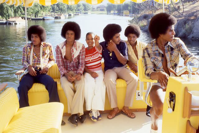 <p>Gregg Cobarr/WireImage</p> Janet Jackson (center) with brothers Marlon, Michael, Tito, Randy and Jackie Jackson in 1978