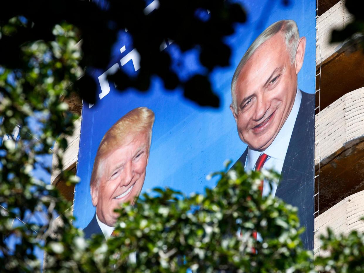 Two giant Israeli Likud Party election banners hanging from a building in Tel Aviv show Israeli Prime Minister Benjamin Netanyahu shaking hands with US President Donald Trump, 28 July 2019: JACK GUEZ/AFP/Getty Images