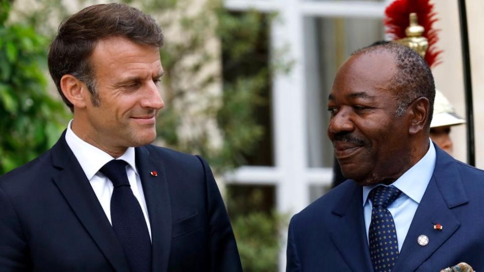 French President Emmanuel Macron (L) greets Gabon's President Ali Bongo Odimba at the Élysée Palace in Paris, 22 June 2023