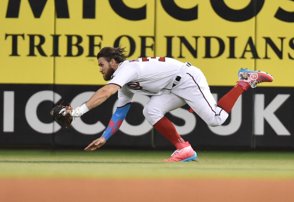 <p>National League outfielder Bryce Harper (34) makes a diving catch on a ball hit by American League catcher Salvador Perez in the second inning during the 2017 MLB All-Star Game at Marlins Park. (Steve Mitchell-USA TODAY Sports) </p>