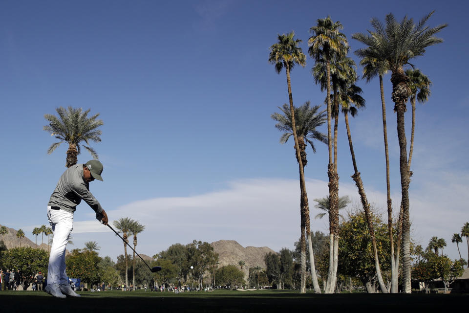 Rickie Fowler hits from the fifth tee during the first round of The American Express golf tournament at La Quinta Country Club on Thursday, Jan. 16, 2020, in La Quinta, Calif. (AP Photo/Marcio Jose Sanchez)