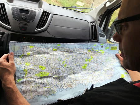 Dr. Humberto Guzman reviews a map of Puerto Rico to find remote villages cut off from medical access in the days since Hurricane Maria in Orocovis, Puerto Rico on October 3, 2017. REUTERS/Robin Respaut