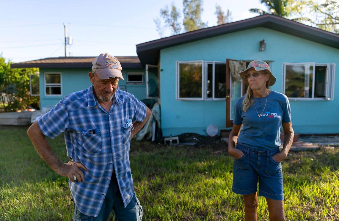 Chuck, 72, and his wife, Jennifer, 65, stand outside of their Hurricane Ian-damaged home on Tuesday, Oct. 18, 2022, in Bonita Shores in Southwest Florida.