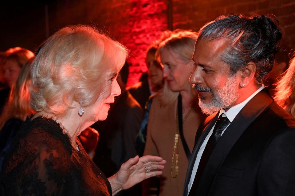 Britain's Camilla, Queen Consort talks with shortlisted author Shehan Karunatilaka, before he was announced as winner, during the Booker Prize at the Roundhouse in London, Monday Oct. 17, 2022.  (Toby Melville/Pool Photo via AP)