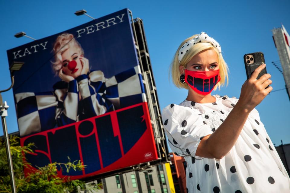 Katy Perry takes a selfie with a billboard promoting her new album "Smile," near her record label, Capitol Records.