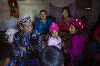 Family and neighbors gather in the home of migrant Rivaldo Jimenez, in Comitancillo, Guatemala, Wednesday, Jan. 27, 2021. Jimenez family members believe he may be one of the charred corpses found in a northern Mexico border state on Saturday. The country's Foreign Ministry said it was collecting DNA samples from a dozen relatives to see if there was a match with any of the bodies. (AP Photo/Oliver de Ros)