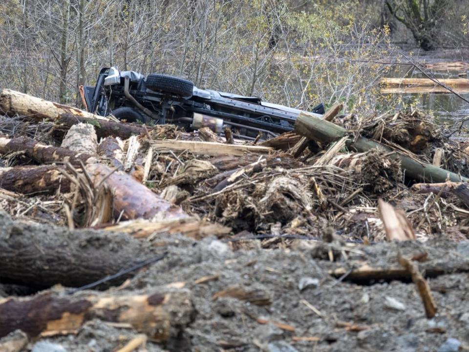 A vehicle is seen in the debris at the Highway 7 mudslide west of Agassiz, B.C., Saturday, Nov. 20, 2021. Widespread flooding in B.C. is being blamed in part on climate change. (Jonathan Hayward/The Canadian Press - image credit)