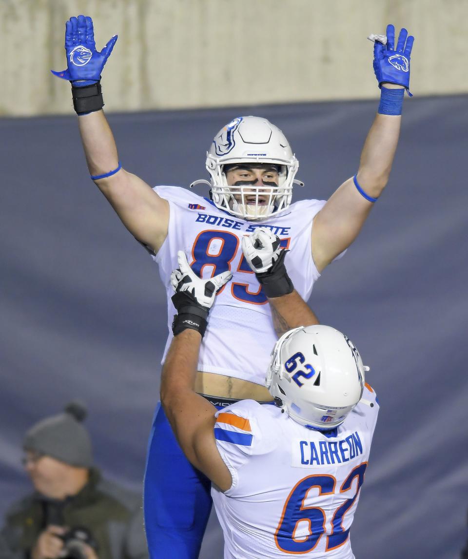 Boise State tight end Matt Lauter (85) celebrates with offensive lineman Roger Carreon (62) after catching a 26-yard touchdown pass against Utah State in the first half of an NCAA college football game Saturday, Nov. 18, 2023, in Logan, Utah. | Eli Lucero/The Herald Journal via AP