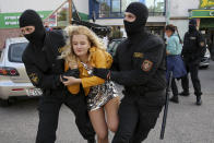 Police officers detain a woman during an opposition rally to protest the official presidential election results in Minsk, Belarus, Saturday, Sept. 19, 2020. Daily protests calling for the authoritarian president's resignation are now in their second month and opposition determination appears strong despite the detention of protest leaders. (AP Photo/TUT.by)