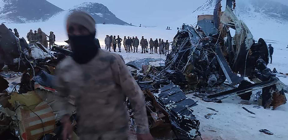 Soldiers and rescue workers stand around the wreckage after an army helicopter crashed in Bitlis, eastern Turkey, Thursday March 4, 2021. Turkey’s Defense Ministry says a military helicopter has crashed, killing several soldiers on board and injuring others. News reports said the victims included an army corps commander. The ministry described the crash as an accident, but it wasn’t immediately known what caused it. (IHA via AP )