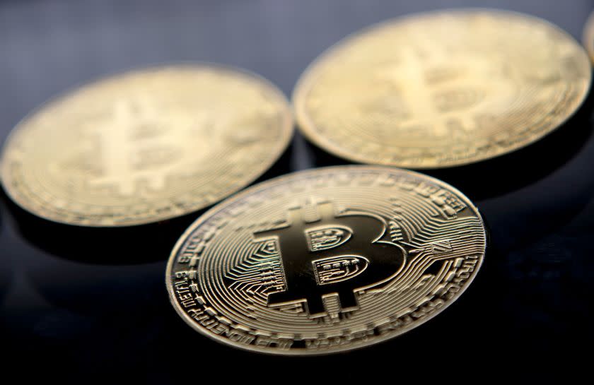 (FILES) This file photo taken on November 20, 2017 shows gold plated souvenir Bitcoin coins arranged for a photograph in London. Bitcoin, which this week soared to a new record high of more than $8,000, is the monetary equivalent of Uber, since it bypasses central bank regulation and could be attractive for financially fragile countries, economists say. Nevertheless, it is precisely the lack of oversight that opens up the users of cryptocurrencies such as bitcoin to risks and dangers, analysts warn. / AFP PHOTO / Justin TALLISJUSTIN TALLIS/AFP/Getty Images ** OUTS - ELSENT, FPG, CM - OUTS * NM, PH, VA if sourced by CT, LA or MoD **