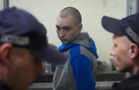 Russian army Sergeant Vadim Shishimarin, 21, is seen behind a glass during a court hearing in Kyiv, Ukraine, Wednesday, May 18, 2022. The Russian soldier has gone on trial in Ukraine for the killing of an unarmed civilian. The case that opened in Kyiv marked the first time a member of the Russian military has been prosecuted for a war crime since Russia invaded Ukraine 11 weeks ago. (AP Photo/Efrem Lukatsky)