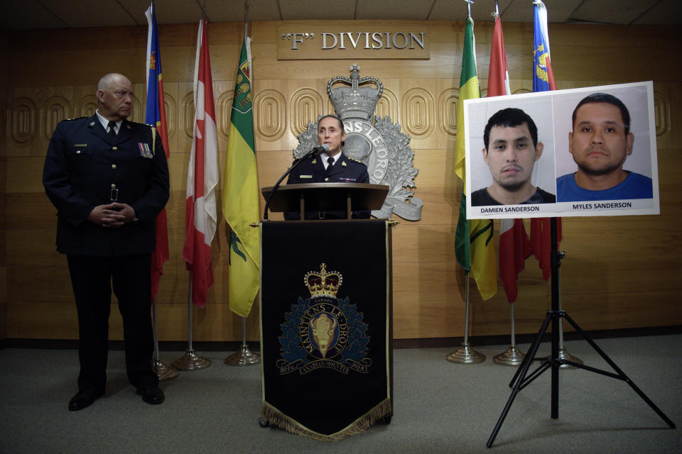 Assistant Commissioner Rhonda Blackmore speaks while Regina Police Chief Evan Bray, left, looks on during a press conference at RCMP "F" Division Headquarters in Regina, Saskatchewan, on Sunday, Sept. 4, 2022. Damien Sanderson and Myles Sanderson allegedly stabbed and killed 10 people between James Smith Cree Nation and Weldon, Saskatchewan, on Sunday morning, and the pair are presently at large. (Michael Bell/The Canadian Press via AP)