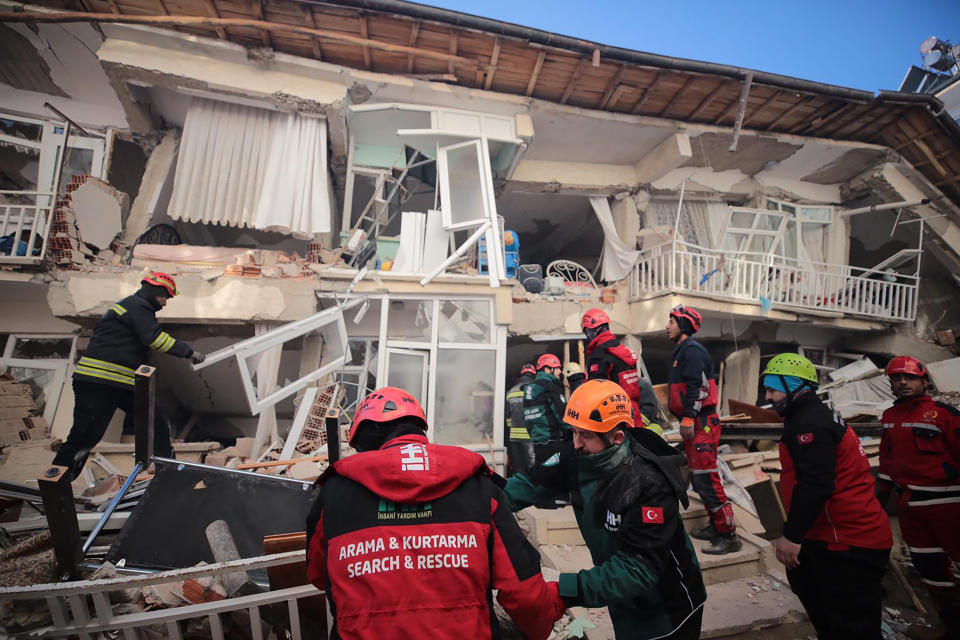 Rescuers search for people buried under the rubble on a collapsed building, after an earthquake struck Elazig, eastern Turkey, Saturday, Jan. 25, 2020. Emergency workers and security forces distributed tents, beds and blankets as overnight temperatures dropped below freezing in the affected areas. Mosques, schools, sports halls and student dormitories were opened for hundreds who left their homes after the quake. (IHH/ Humanitarian Relief Foundation via AP)