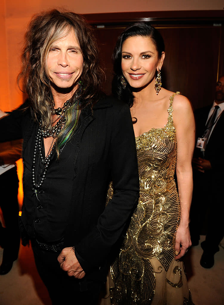 Steven Tyler and Catherine Zeta-Jones attend the 2013 Vanity Fair Oscar Party hosted by Graydon Carter at Sunset Tower on February 24, 2013 in West Hollywood, California.
