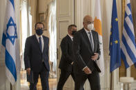 Foreign Ministers of Greece Nikos Dendias, front Israel Gabi Ashkenazi , and Cyprus Nikos Christodoulides, left, arrive for a news conference after their meeting in Athens, on Tuesday, Oct. 27, 2020. (AP Photo/Petros Giannakouris)