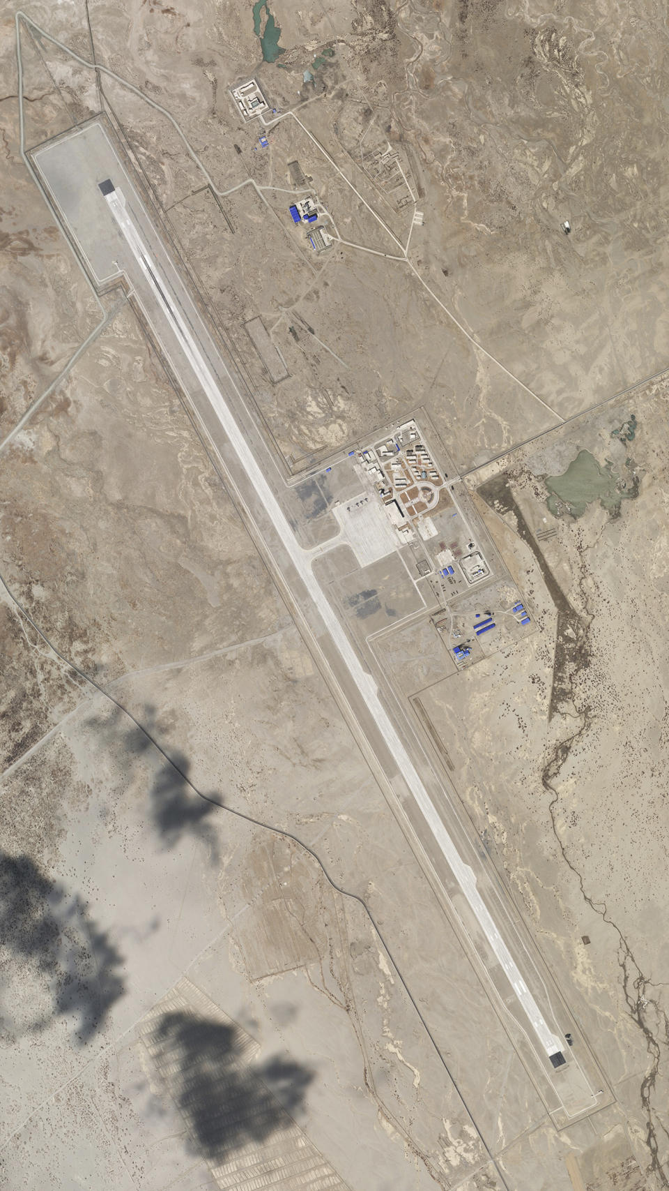 In this satellite image provided by Planet Labs, the Ngari Günsa civil-military airport base taken on April 1, 2020, near the border with India in far western region of Tibet in China shows development around the airport. Tensions along the China-India border high in the Himalayas have flared again in recent weeks. Indian officials say the latest row began in early May, when Chinese soldiers entered the Indian-controlled territory of Ladakh at three different points, erecting tents and guard posts. China has sought to downplay the confrontation while providing little information. (Planet Labs via AP)