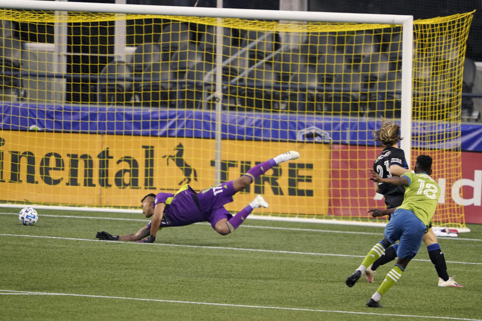 Seattle Sounders' Kelvin Leerdam, right, kicks a goal against San Jose Earthquakes goalkeeper Daniel Vega, left, and Florian Jungwirth, second from right, during the first half of an MLS soccer match Thursday, Sept. 10, 2020, in Seattle. (AP Photo/Ted S. Warren)