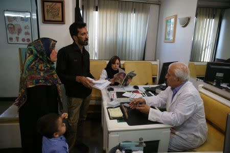 Emad, two, and his parents visit his doctor Mr. Khorasandy in north of Tehran, Iran, June 19, 2017. Nazanin Tabatabaee Yazdi / TIMA via REUTERS.