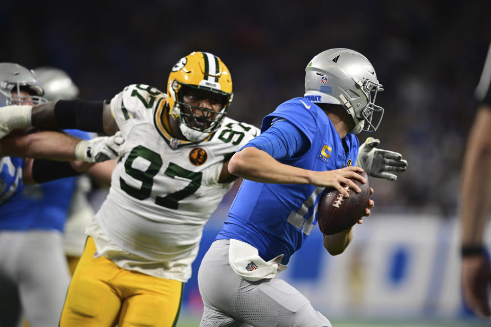 Green Bay Packers defensive tackle Kenny Clark (97) chanses Detroit Lions quarterback Jared Goff (16) during the second half of an NFL football game, Thursday, Nov. 23, 2023, in Detroit. (AP Photo/David Dermer)