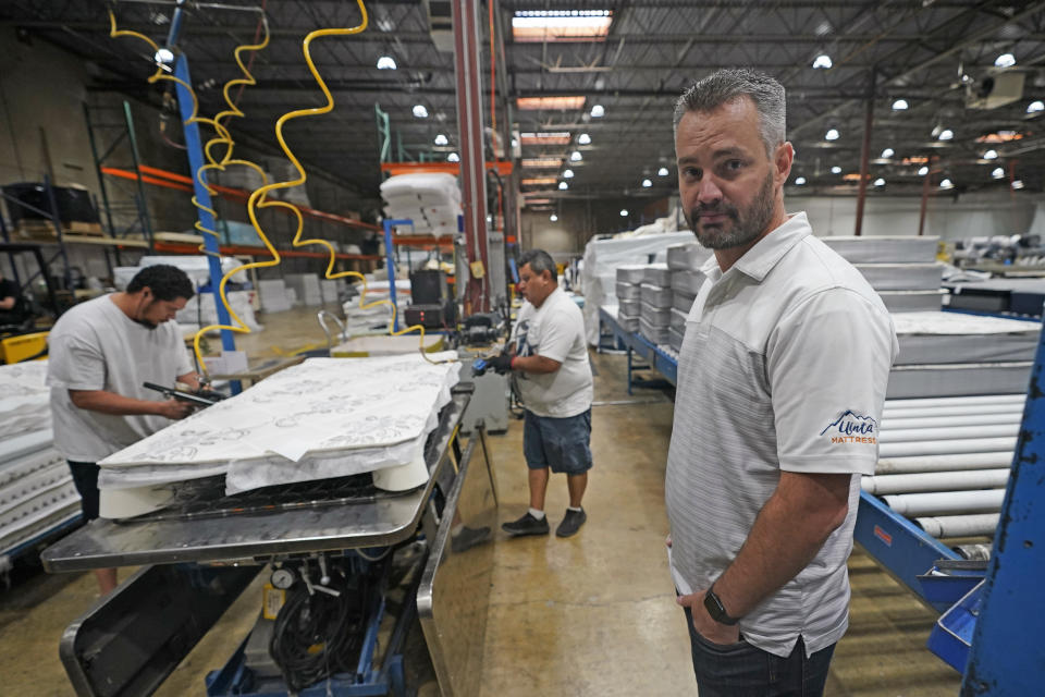 Mattress maker Schuyler Northstrom, of Uinta Mattress, looks on during production in his warehouse Friday, Sept. 9, 2022, in Salt Lake City. Inflation and rising costs for everything from labor to raw materials have forced many small businesses to raise prices. Northstrom saw a drop in customer demand after raising prices. (AP Photo/Rick Bowmer)
