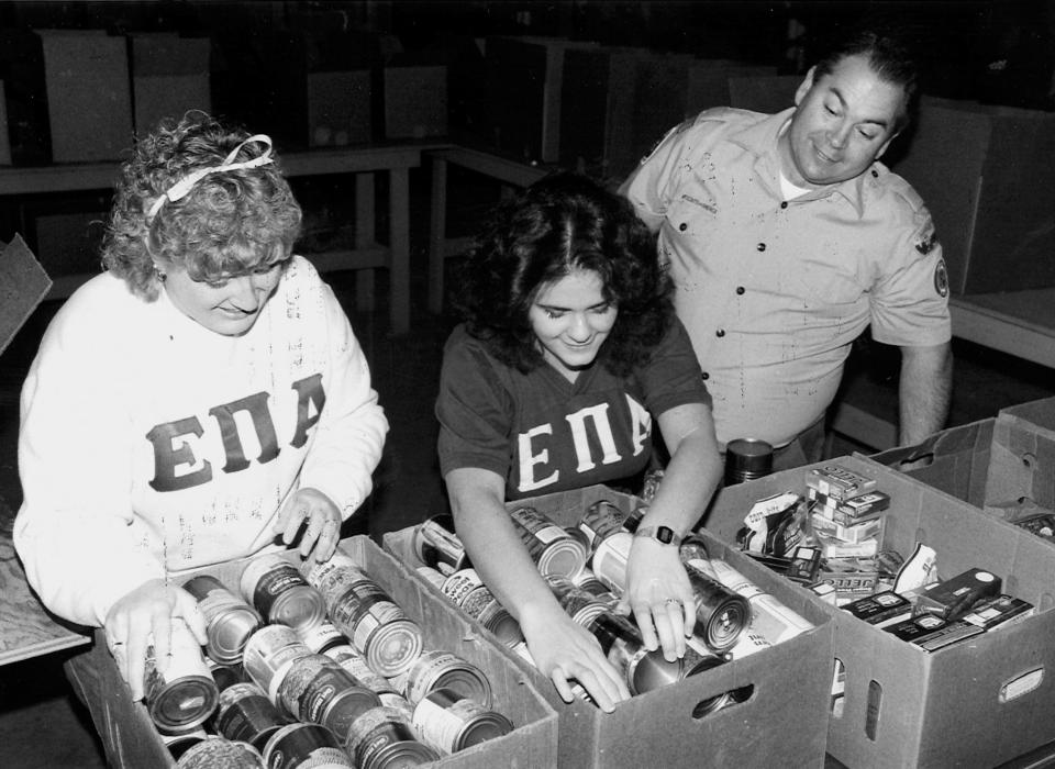 Hardin-Simmons University students Sherry Smith and Joy Cole sort cans with John Tankersley at the Food Bank of Abilene.