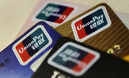 Logos of China UnionPay are seen on bank cards in this photo illustration taken in Beijing December 5, 2013. Picture taken December 5, 2013. REUTERS/Barry Huang