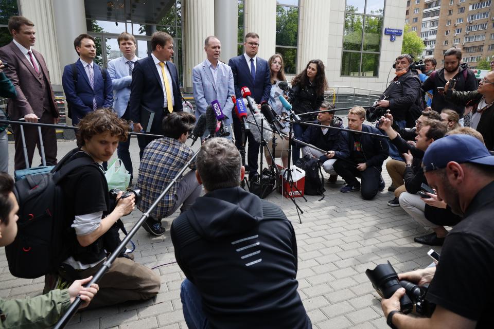 Russian lawyer Ivan Pavlov, center, speaks to the media as other lawyers stand around him during a break in a court session in front of Moscow Court in Moscow, Russia, Wednesday, June 9, 2021. A court is expected to outlaw the organizations founded by Russian opposition leader Alexei Navalny. Prosecutors have asked the Moscow City Court to designate Navalny's Foundation for Fighting Corruption and his sprawling network of regional offices as extremist organizations. The extremism label also carries lengthy prison terms for activists who have worked with the organizations, anyone who donated to them, and even those who simply shared the groups' materials. (AP Photo/Alexander Zemlianichenko)