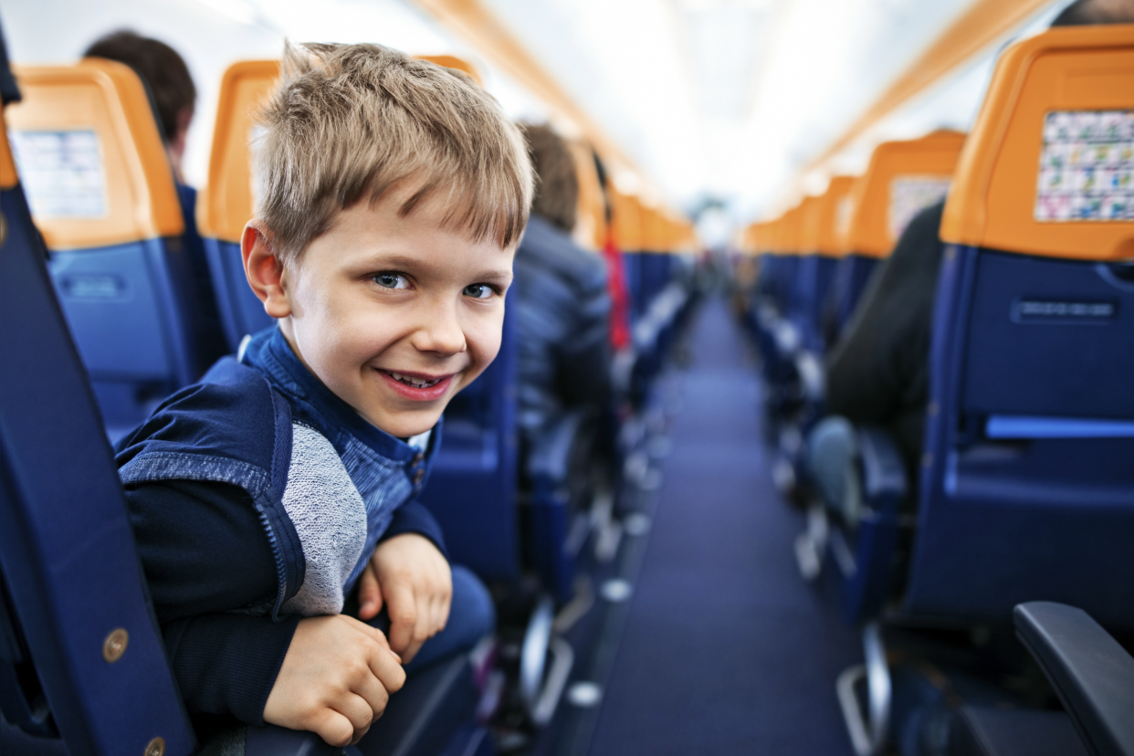 Young boy sitting by himself on an airplane