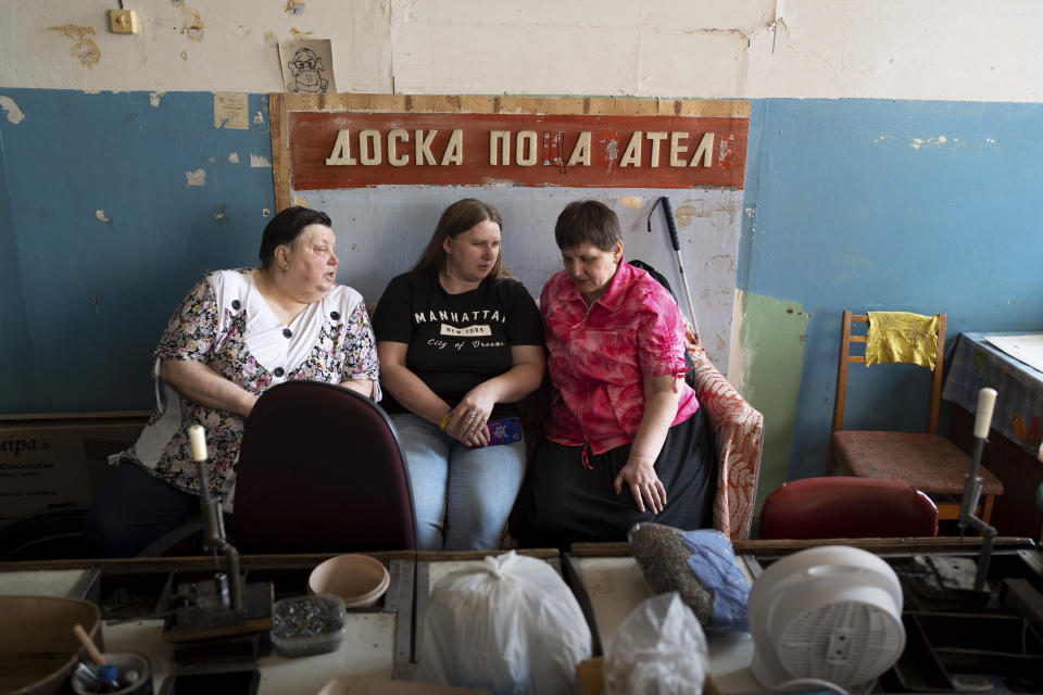 Three women sit in Kyiv, Ukraine, May 30, 2023 in a manufacturing plant where visually impaired people worked until it was shuttered due to attacks of Russian-fired drones. Losing the place of work is just one of a multitude of challenges that people with visual impairments face across Ukraine since Russia launched a full-scale invasion in February 2022. (AP Photo/Roman Hrytsyna)